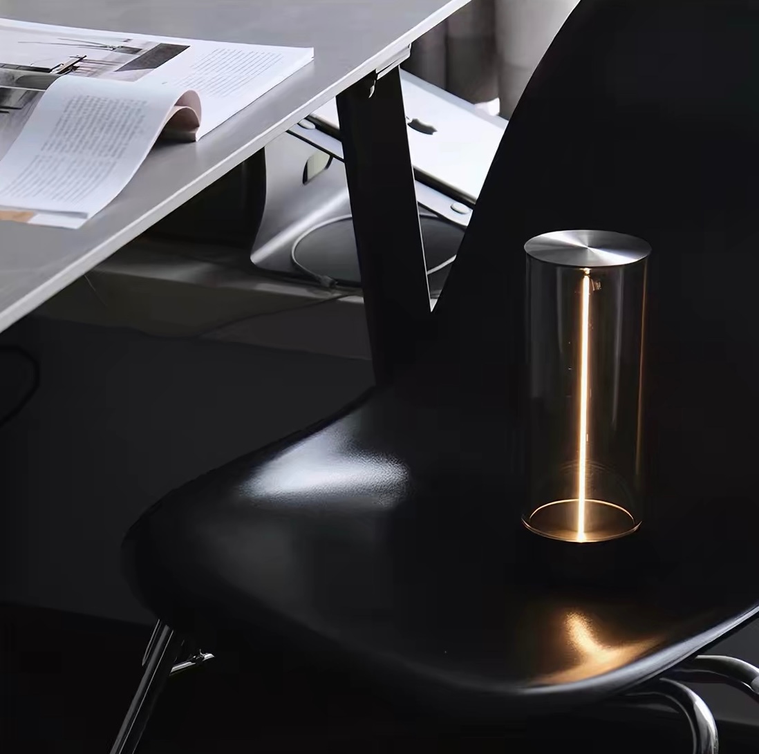 Amber glass bar pendant casting a warm glow over a dark stone counter