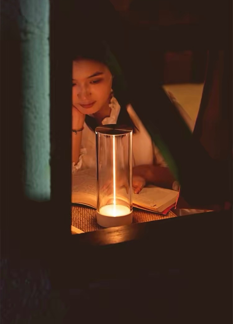 Compact orange glass pendant above a round walnut dining table at dusk