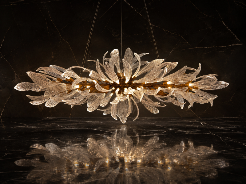 Akary lighting, furniture and objects arranged in a warm open-plan interior