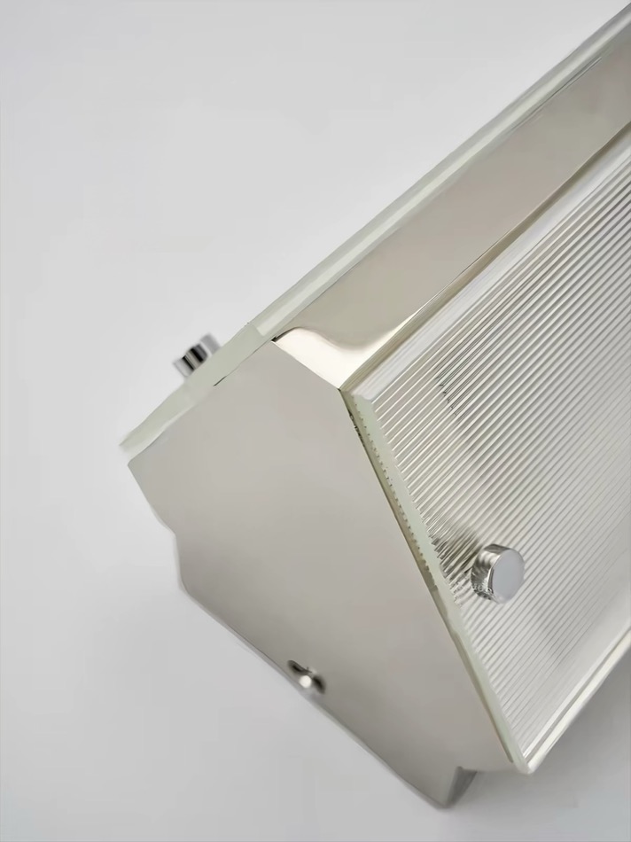Metal frame and glass detail of the Lumen Vault Wall Light