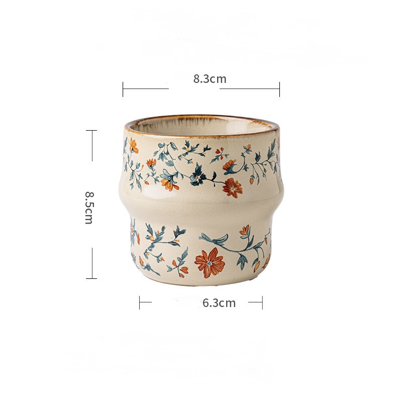 Amber Wildflower cup with orange flowers and dimensions of 8.3 cm across, 8.5 cm tall, and 6.3 cm at the base