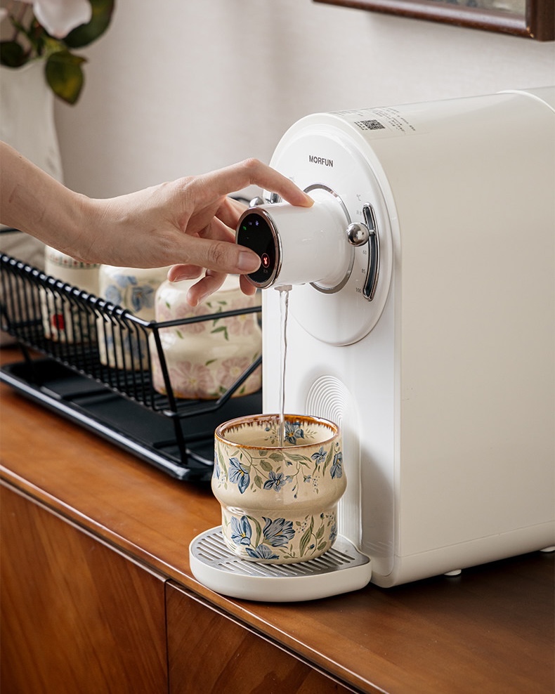 Blue Botanica cup being filled at a countertop water dispenser