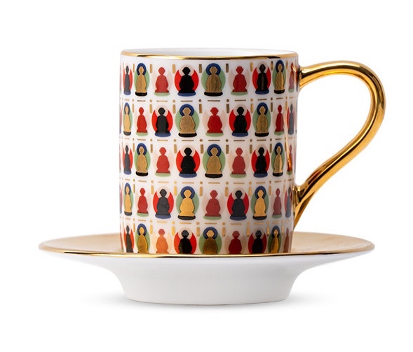 Ivory and gold-tone Dunhuang cup with rows of colourful seated figures and a matching saucer