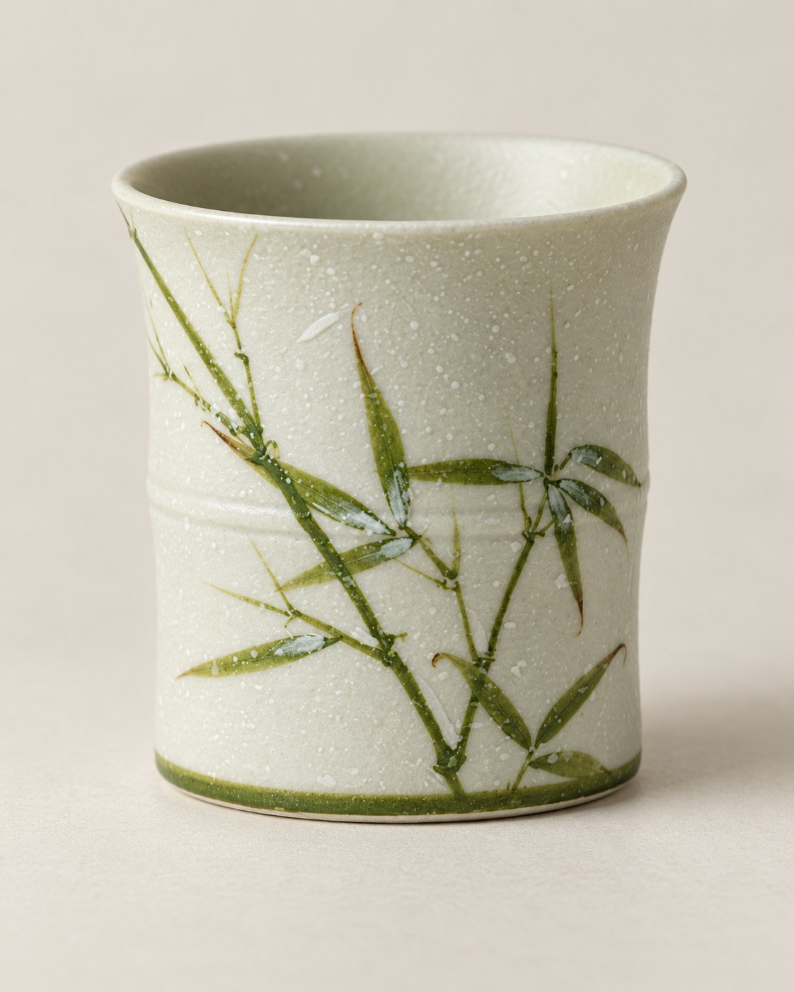 Close-up of the green bamboo motif and pale speckled glaze